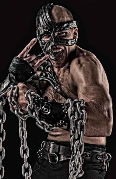 Magnos  wrestler with his custom mask and chains around his left arm.
